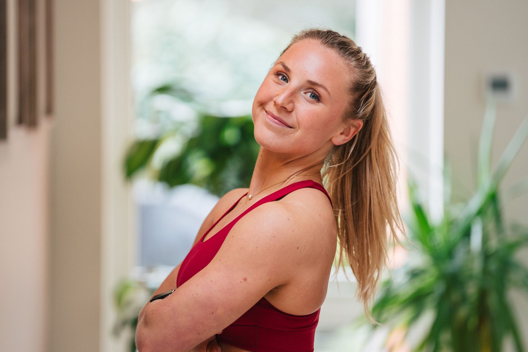 Become Active with Gigi Confident Gigi in activewear smiling indoors with plants in the background